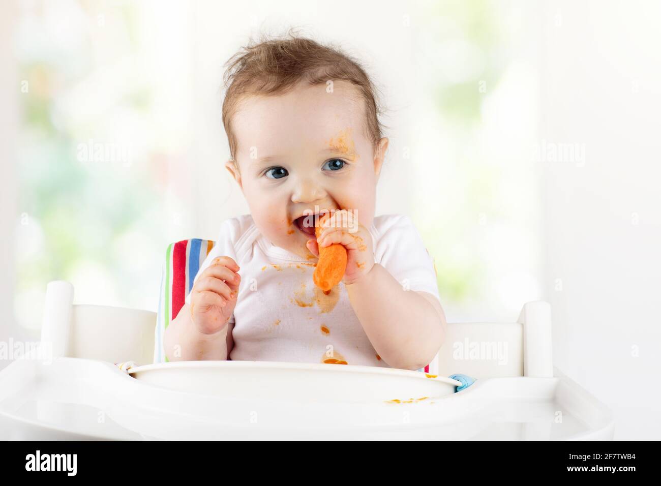 Boy child eating highchair messy mess hi res stock photography and images Alamy