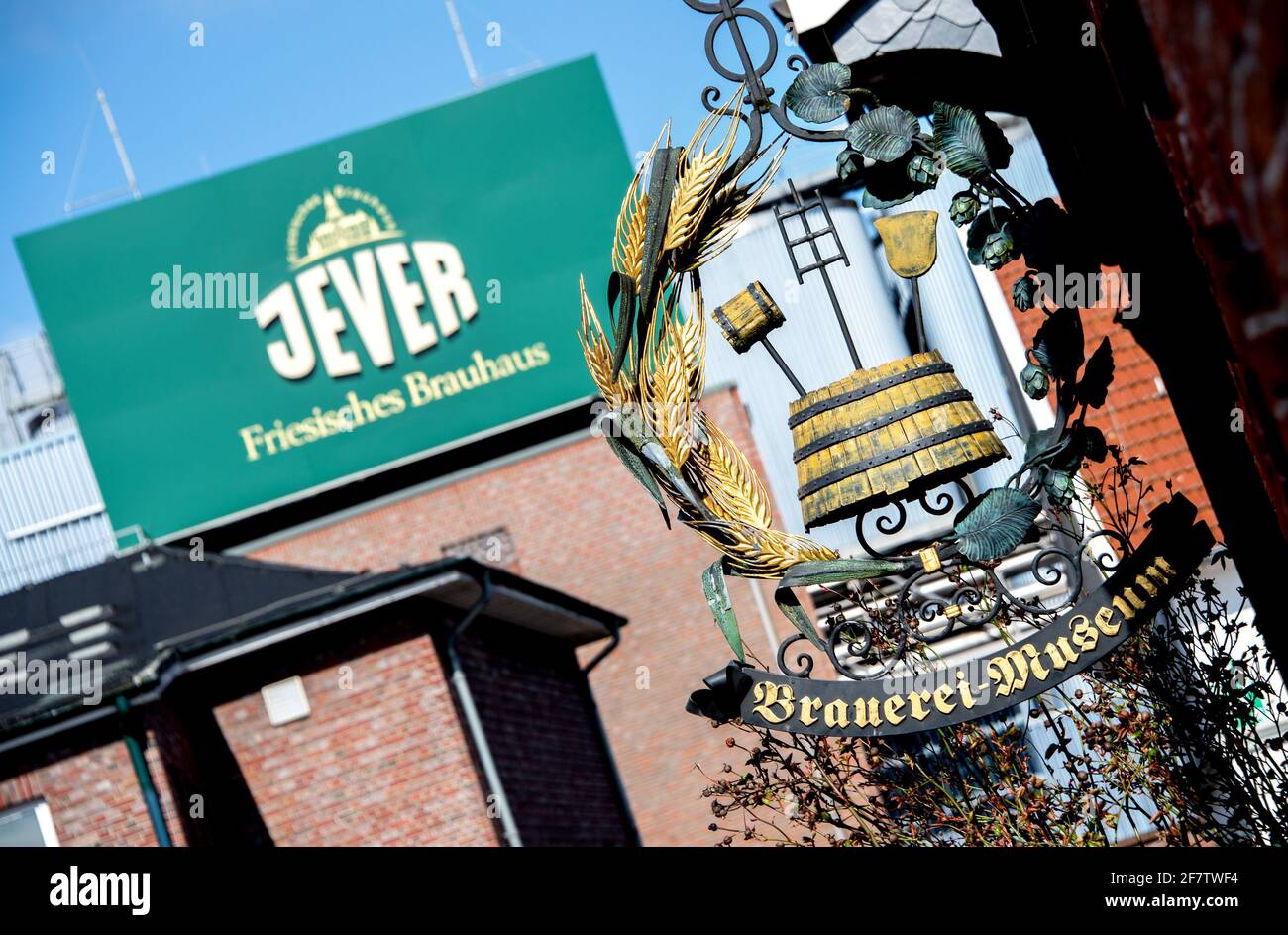 Jever, Germany. 29th Mar, 2021. A historic sign reading 'Brewery Museum' hangs on a house wall in the city center in front of the Friesisches Brauhaus zu Jever. Many breweries in the north have little hope for a good spring season in view of the ongoing Corona crisis. As business with the hospitality industry and in coastal tourism is failing, the Friesisches Brauhaus zu Jever has in the meantime stopped filling draught beer. Credit: Hauke-Christian Dittrich/dpa/Alamy Live News Stock Photo