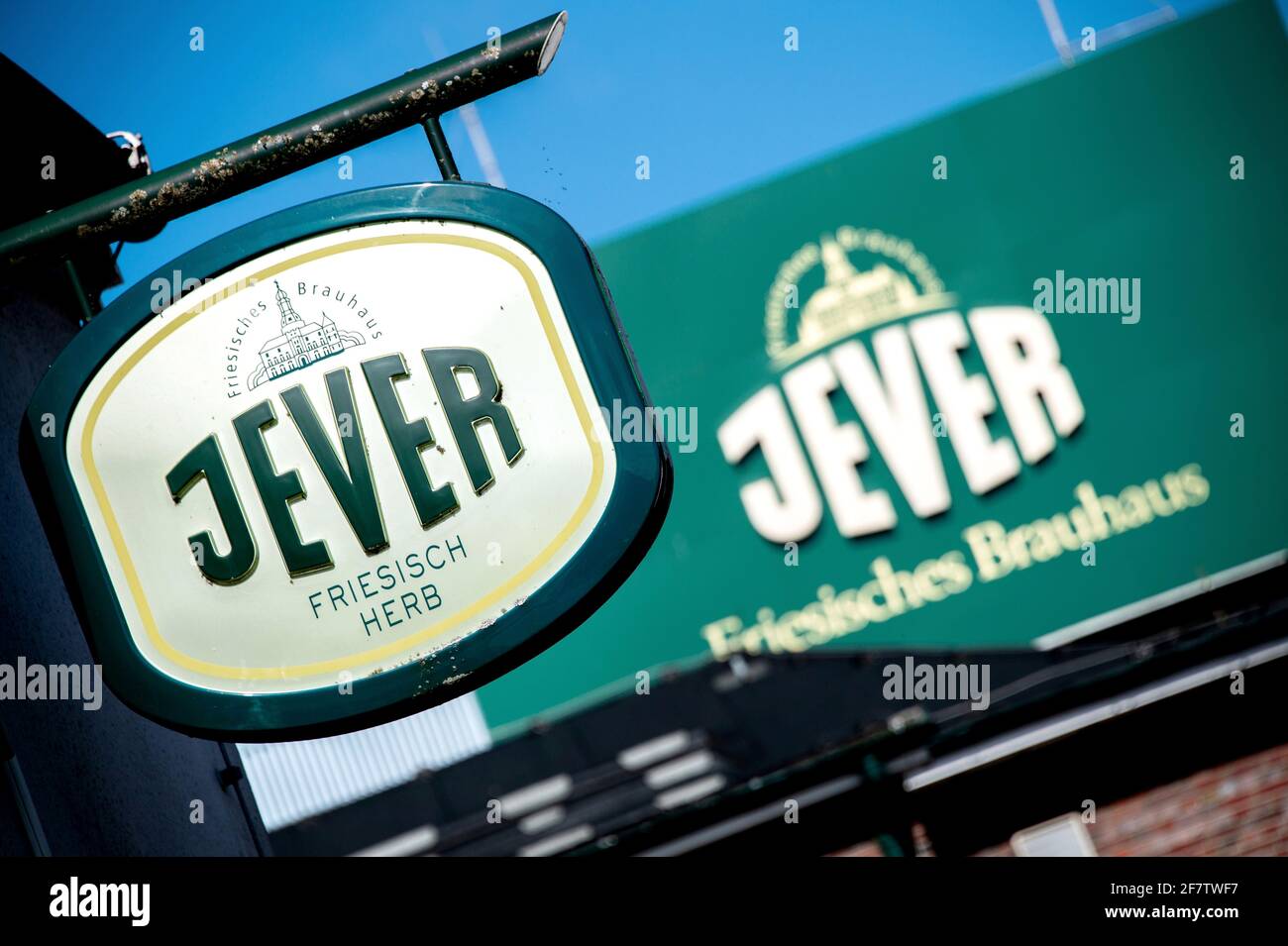 Jever, Germany. 29th Mar, 2021. A neon sign for the 'Jever' beer brand hangs in front of the Friesisches Brauhaus zu Jever in the city center. Many breweries in the north have little hope for a good spring season in view of the ongoing Corona crisis. As business with the hospitality industry and in coastal tourism is failing, the Friesisches Brauhaus zu Jever has in the meantime stopped filling draught beer. Credit: Hauke-Christian Dittrich/dpa/Alamy Live News Stock Photo