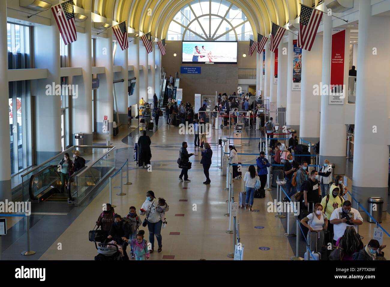 Passengers with face masks at the American Airlines ticket counter in