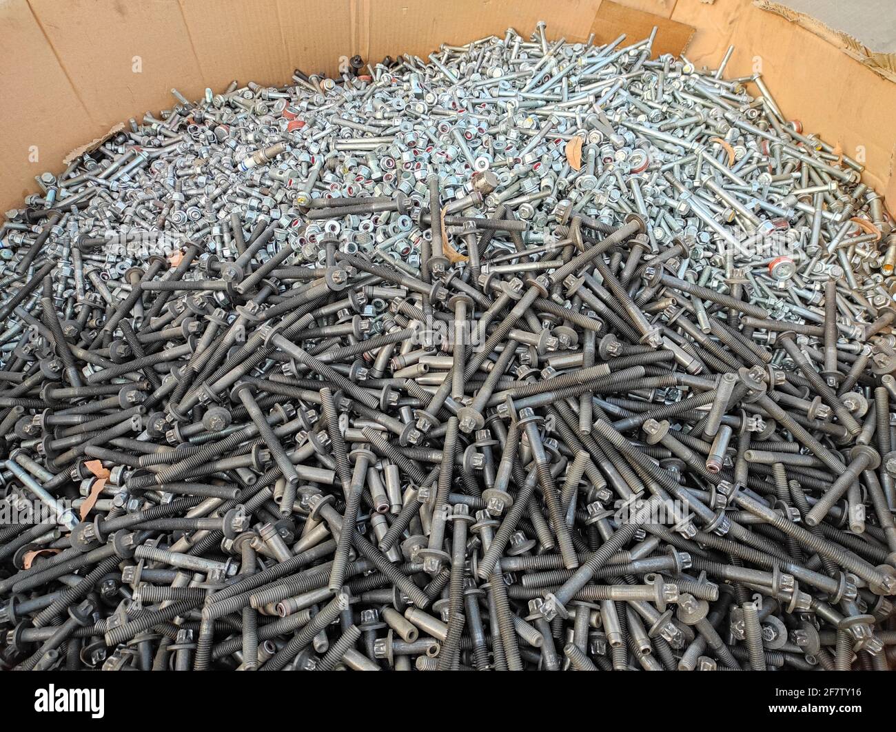 Bunch of bolts and nuts in a cardboard box Stock Photo Alamy