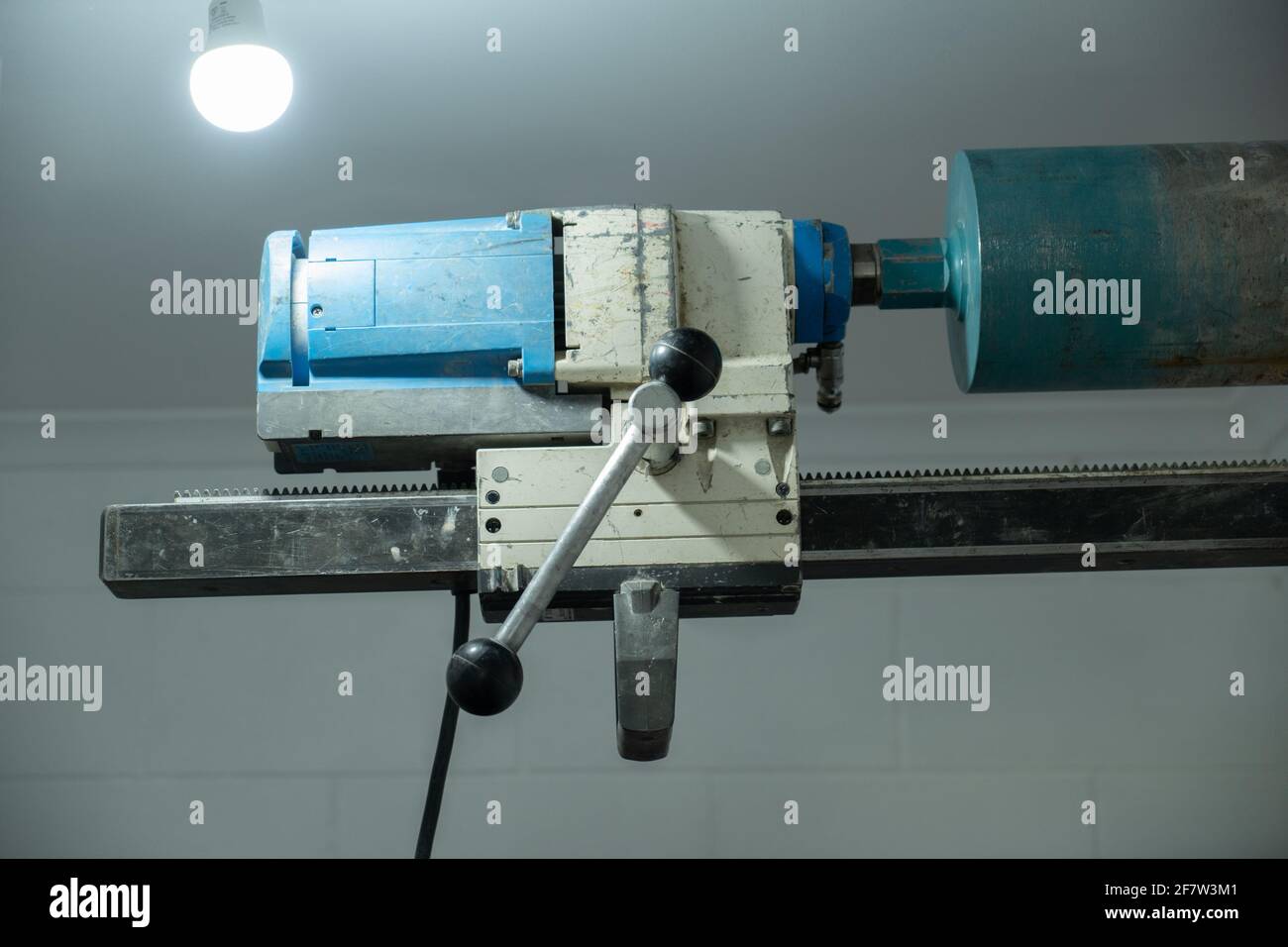 Concrete coring diamond cutting drill bolted to a white wall with an anchor bolt Stock Photo Alamy
