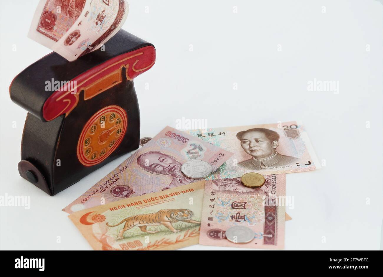 A cash piggy bank or purse with paper banknotes, Vietnamese money, isolated on a white background with a place for Stock Photo