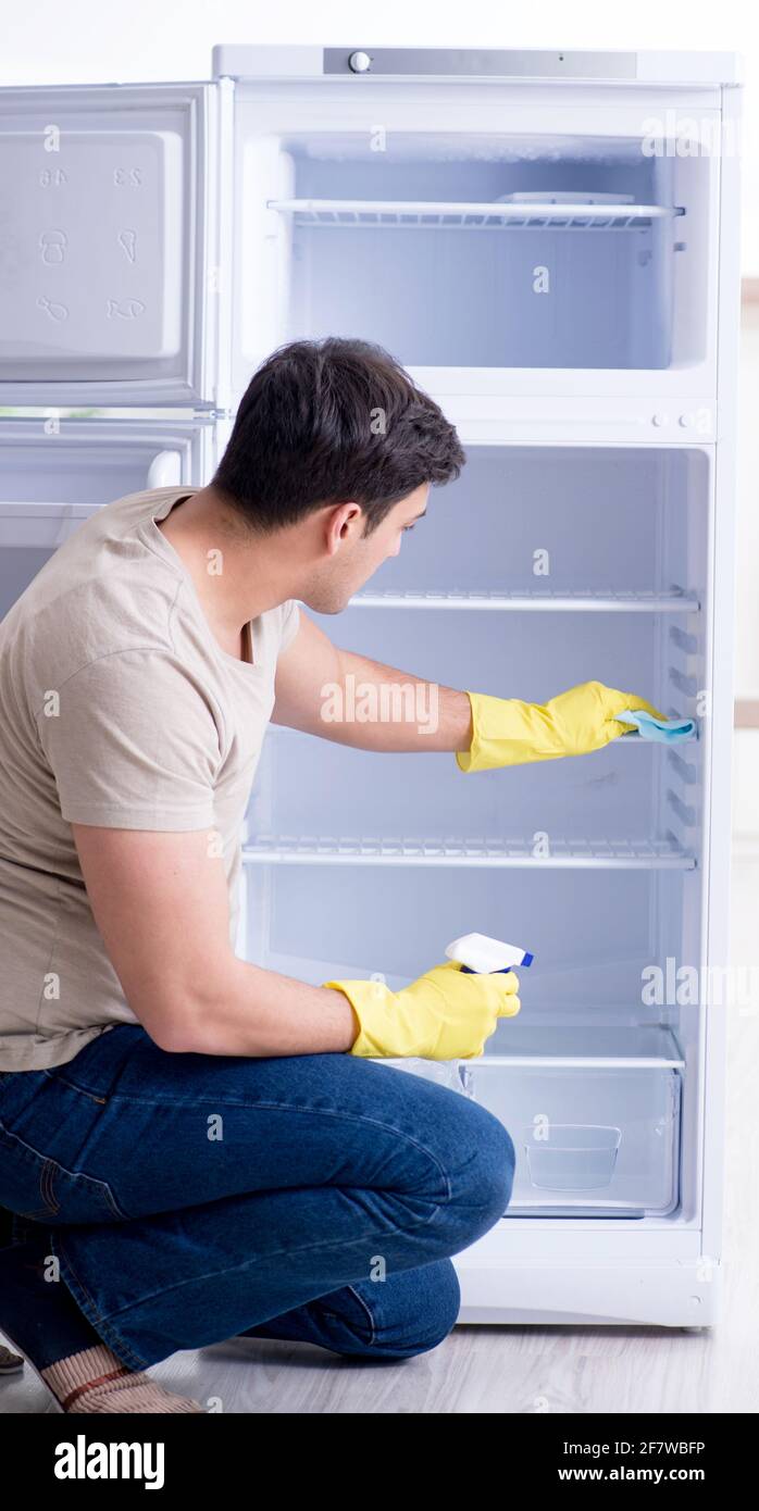 The man cleaning fridge in hygiene concept Stock Photo - Alamy