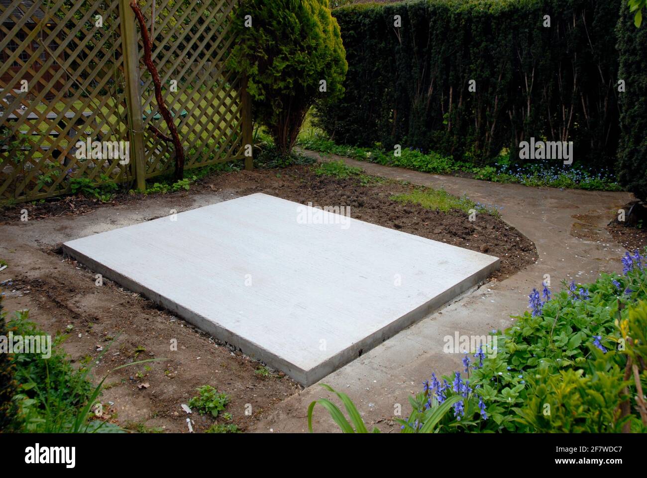Concrete base for outbuilding to be erected on the site in private domestic suburban garden Stock Photo