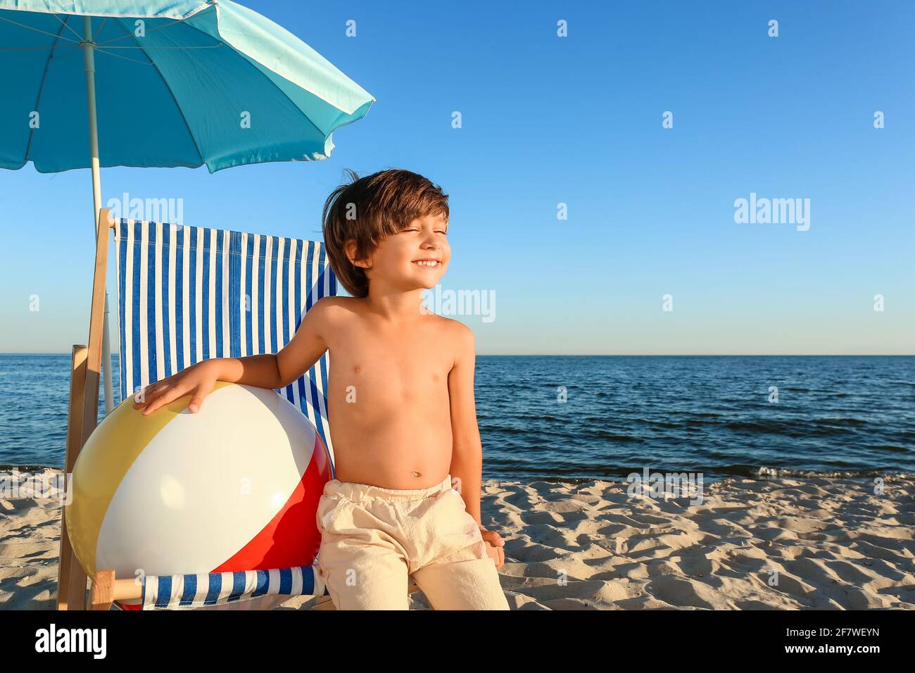 Cute little boy on sea beach Stock Photo - Alamy