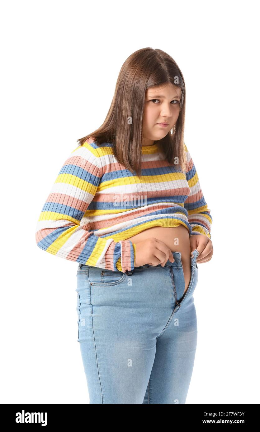 Sad overweight girl in tight clothes on white background Stock Photo - Alamy