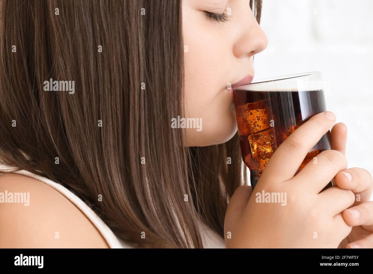 Overweight girl drinking unhealthy soda, closeup Stock Photo Alamy