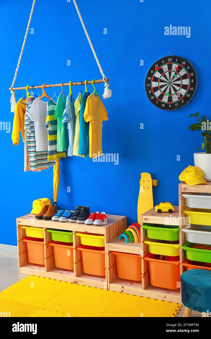 Rack with clothes in interior of children's room Stock Photo - Alamy