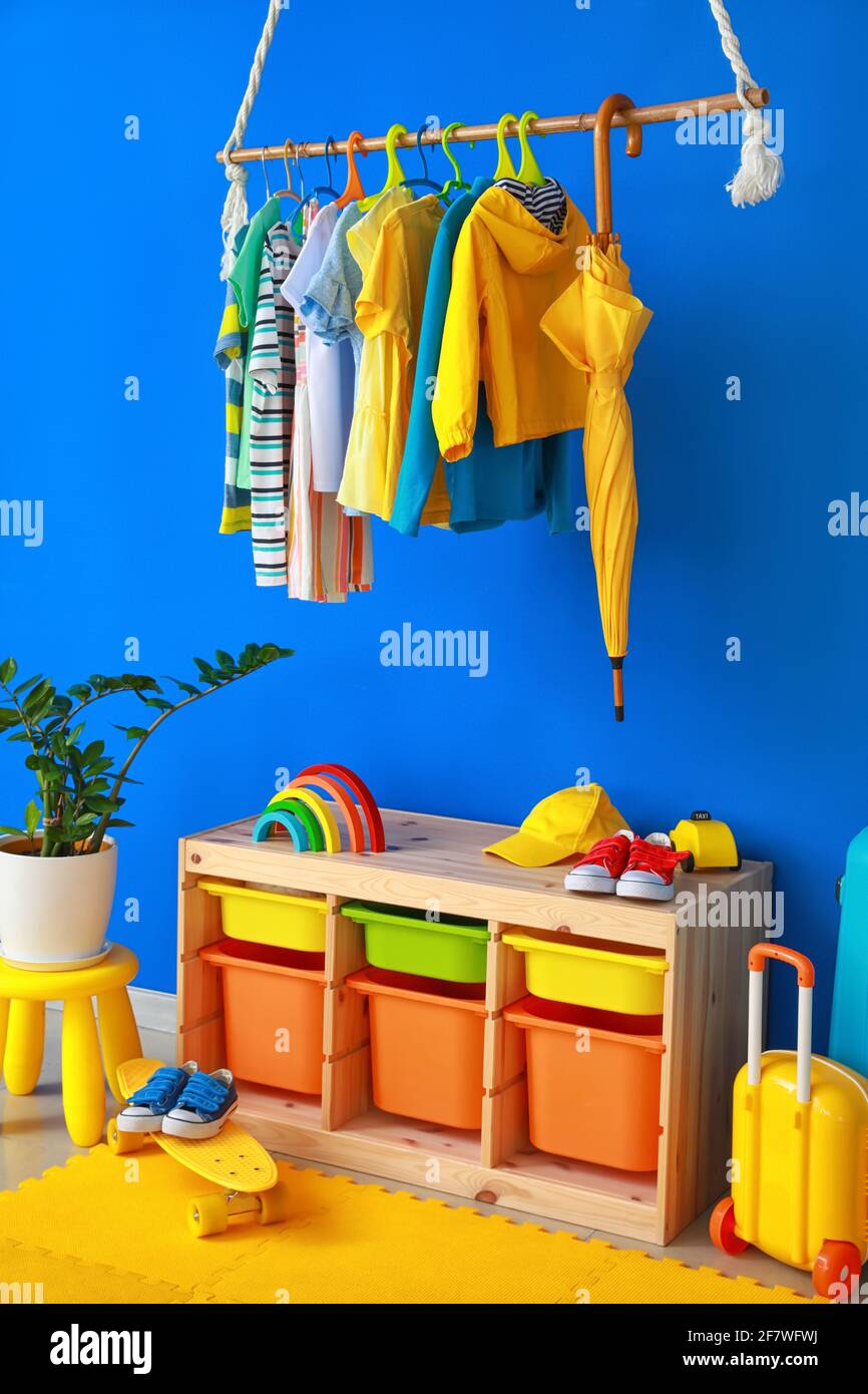 Rack with clothes in interior of children's room Stock Photo - Alamy