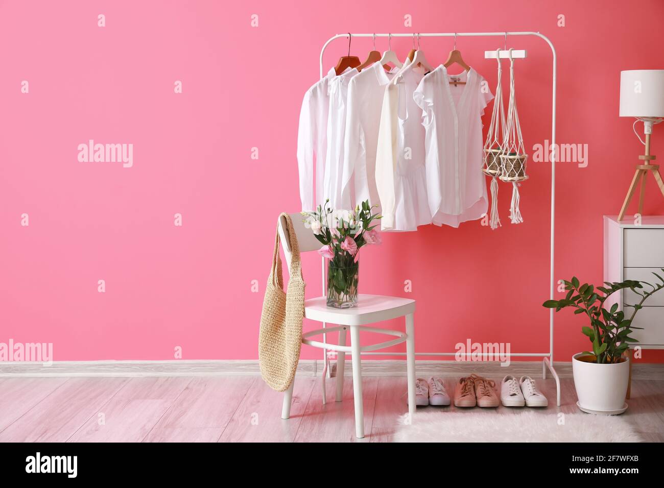 Rack with clothes in interior of modern room Stock Photo - Alamy