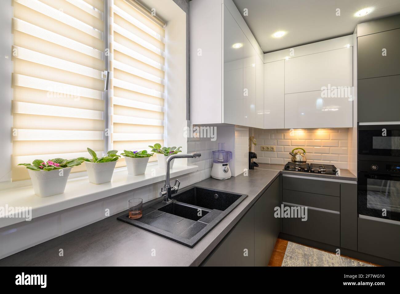 Modern dark grey small kitchen interior Stock Photo - Alamy