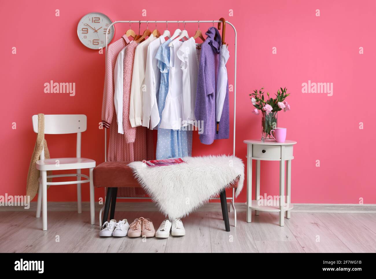 Rack with clothes in interior of modern room Stock Photo - Alamy