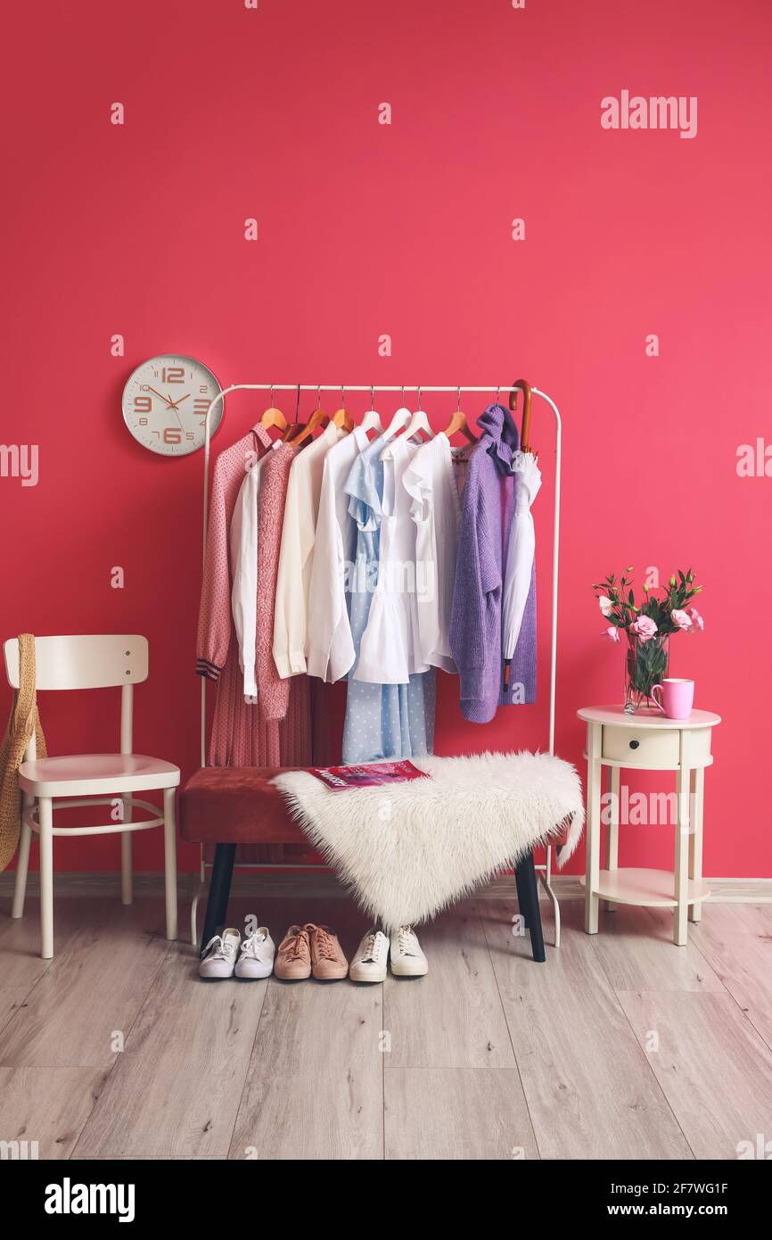 Rack with clothes in interior of modern room Stock Photo - Alamy