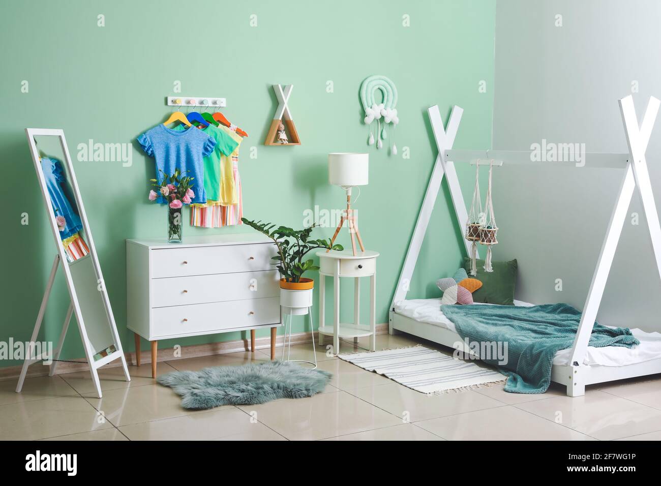 Rack with clothes in interior of children's room Stock Photo - Alamy
