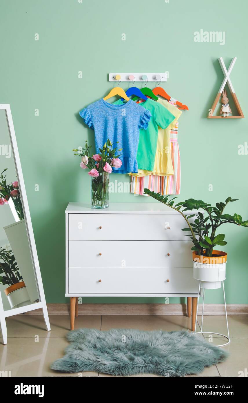 Rack with clothes in interior of children's room Stock Photo - Alamy