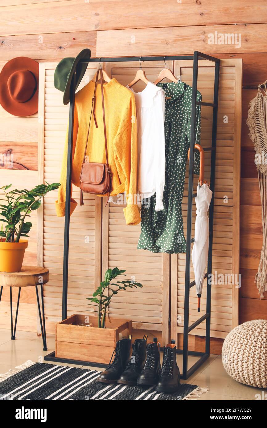 Rack with clothes in interior of modern room Stock Photo - Alamy