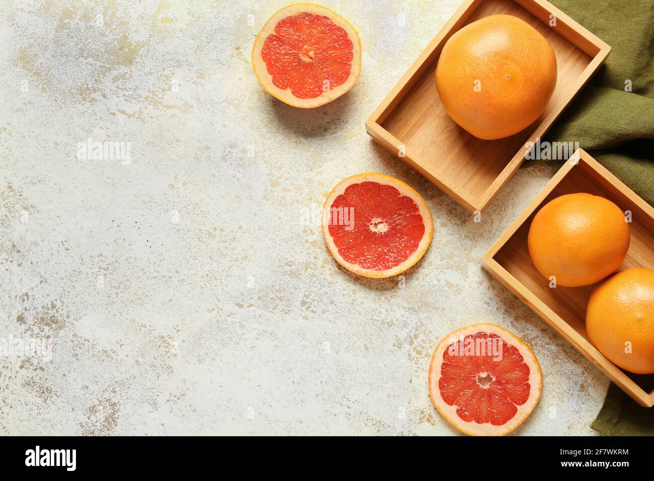 Boxes with ripe grapefruits on light background Stock Photo
