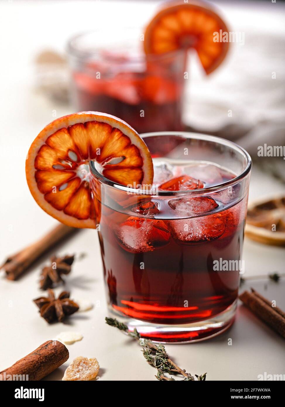 Cold mulled wine with cherry and bloody orange. Vertical shot. Close-up. Alcoholic beverage still life. Stock Photo