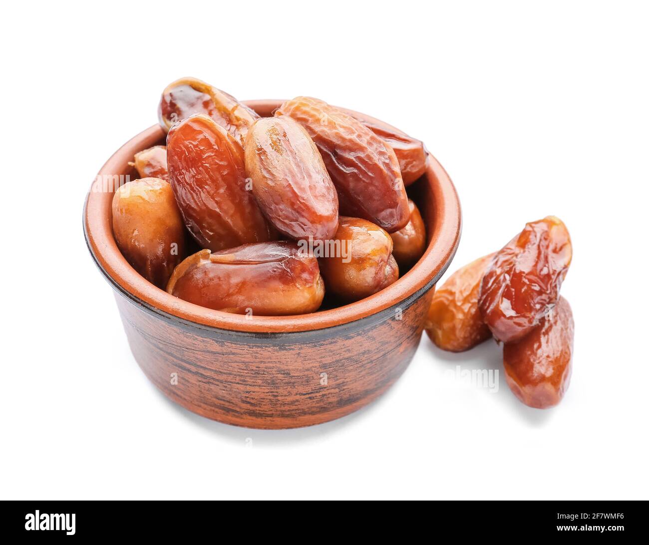 Bowl with sweet dried dates on white background Stock Photo - Alamy
