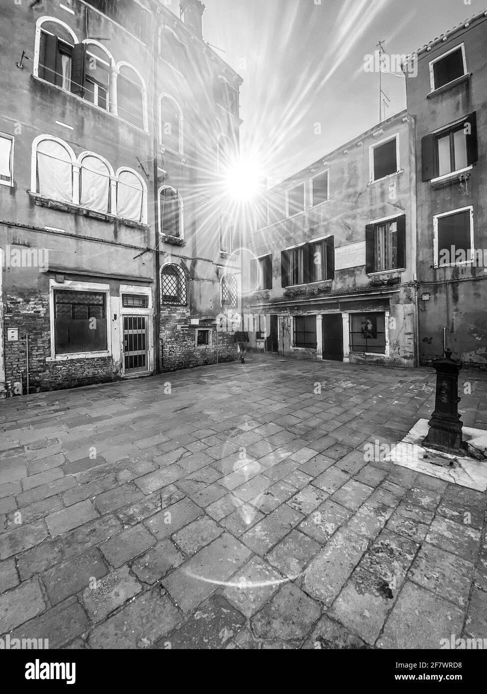 Local people walking in Venice, Sun in backlight, black and white view Stock Photo