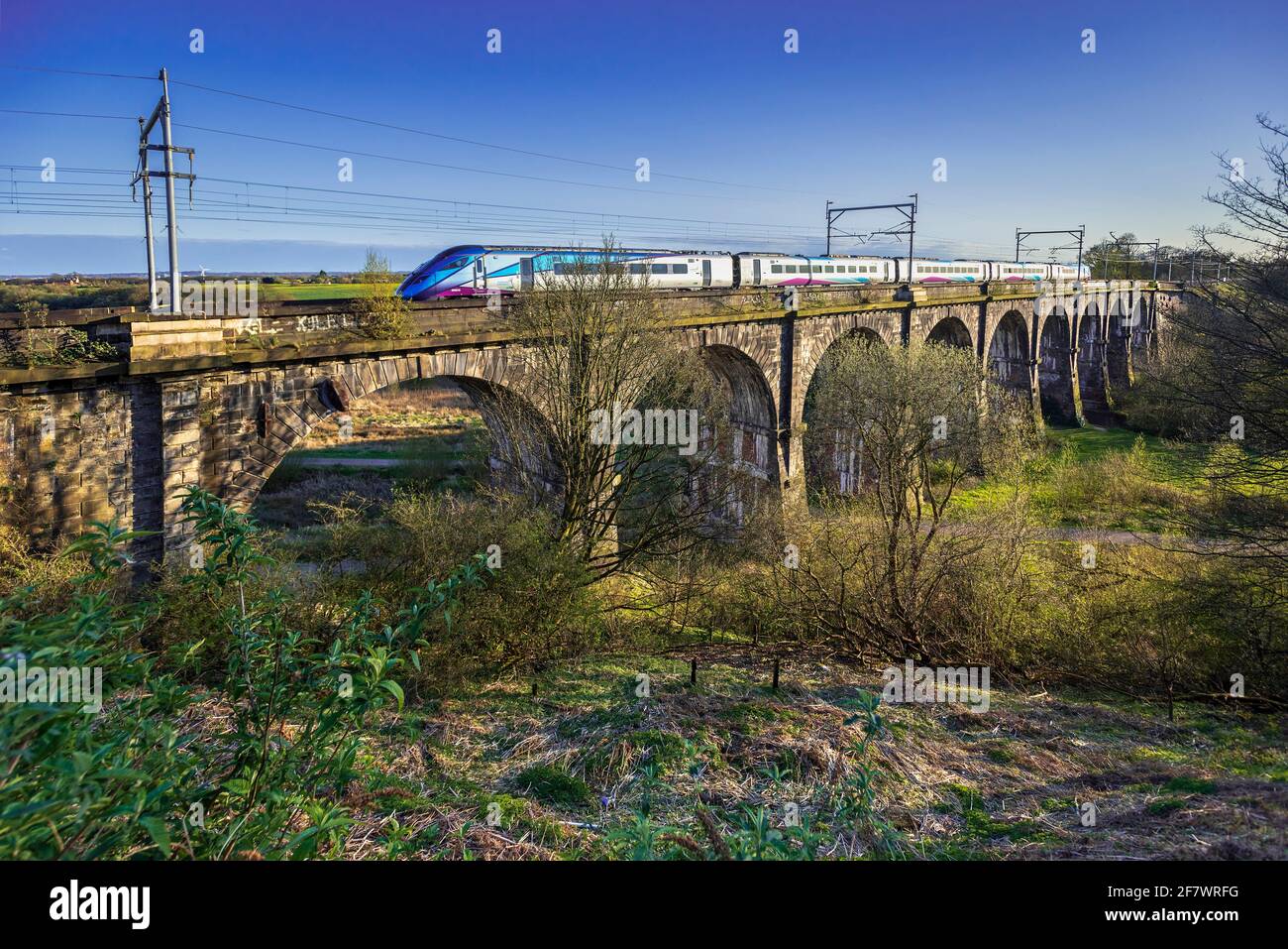 A train crossing the Sankey viaduct at Earlestown over the Sankey Valley.It is the earliest major railway viaduct in the world. Stock Photo