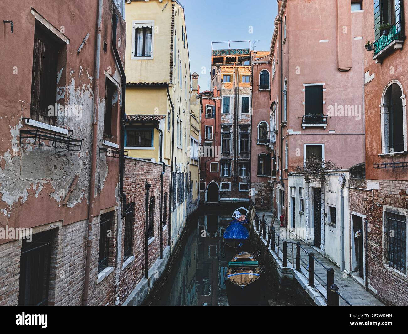 Many Small boats on a small canal street in Venice with beautiful ...