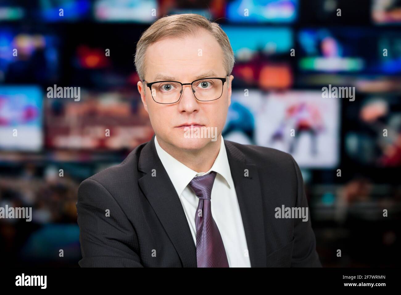 An Anchorman Reporting Live Breaking News Sitting In Tv Studio Background Of Multiple Screens Of Broadcast Control Room Journalism Concept Stock Photo Alamy