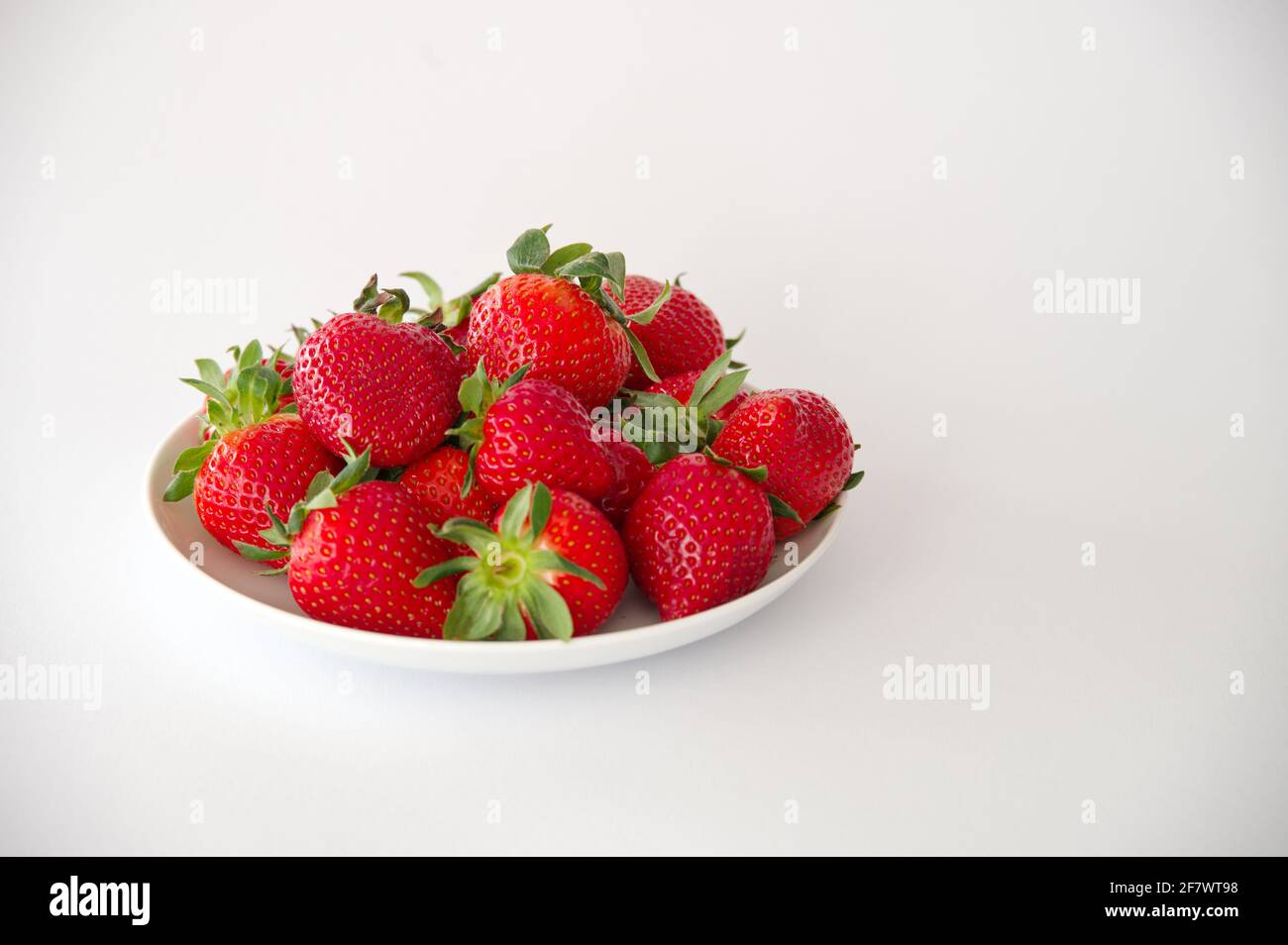 Group of people eating strawberries hi-res stock photography and images ...