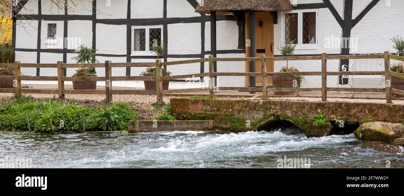 Alresford, Hampshire, England, UK. 2021.  The Fulling Mill circa 13th C and River Arle gushing below this old timber framed building in Alresford, use Stock Photo