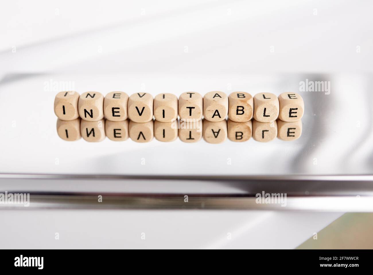 Word inevitable by wooden cubes Stock Photo