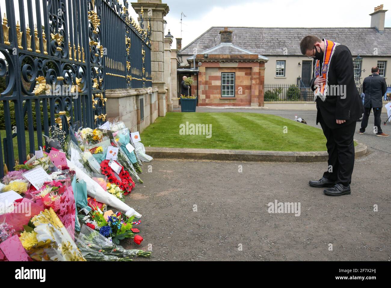 A man bows in front of flowers placed at Hillsborough Castle after Britain's Prince Philip, husband of Queen Elizabeth, died at the age of 99, in Hillsborough, Northern Ireland, April 10, 2021. REUTERS/Jason Cairnduff Stock Photo