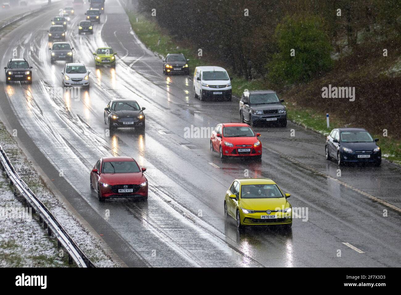 Chorley Lancashire. 10th April 2021 UK Weather;  Motorway mayhem as freak hail stone shower makes driving tricky with a series of collisions in Chorley. 4 wheel drive vehicles in separate incidents collide with the armcor on the M61 central reservation. Credit MediaWorldImages/AlamyLivenews Stock Photo