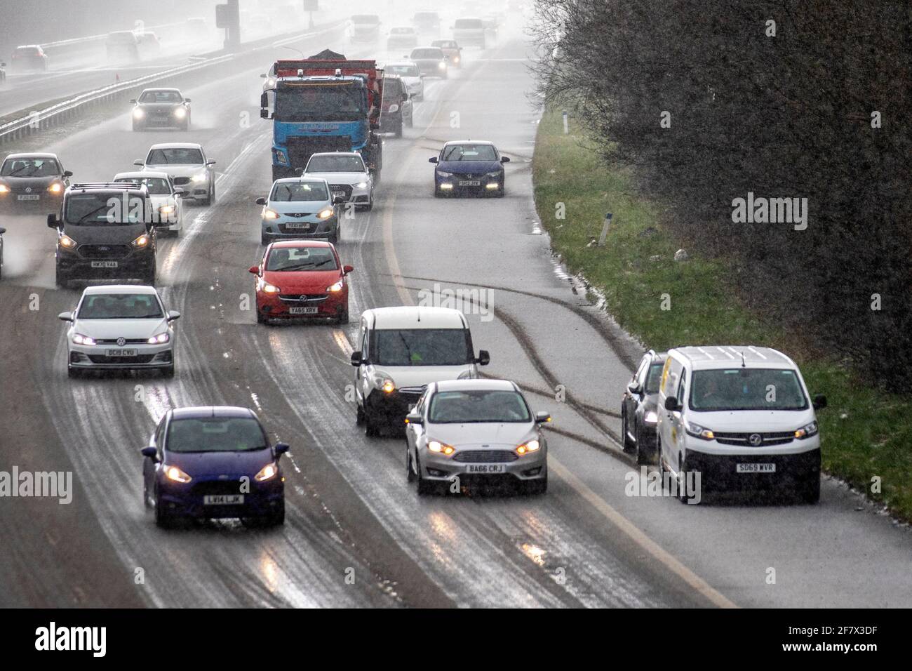 Chorley Lancashire. 10th April 2021 UK Weather;  Motorway mayhem as freak hail stone shower makes driving tricky with a series of collisions in Chorley. 4 wheel drive vehicles in separate incidents collide with the armcor on the M61 central reservation. Credit MediaWorldImages/AlamyLivenews Stock Photo