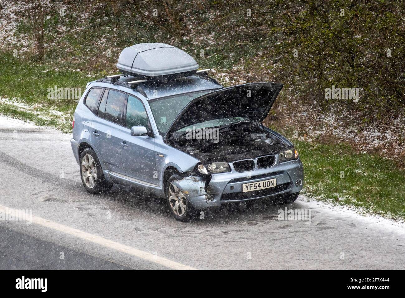Chorley Lancashire. 10th April 2021 UK Weather;  Motorway mayhem as freak hail stone shower makes driving tricky with a series of collisions in Chorley. BMW 4 wheel drive vehicles in separate incidents collide with the armcor on the M61 central reservation. Credit MediaWorldImages/AlamyLivenews Stock Photo