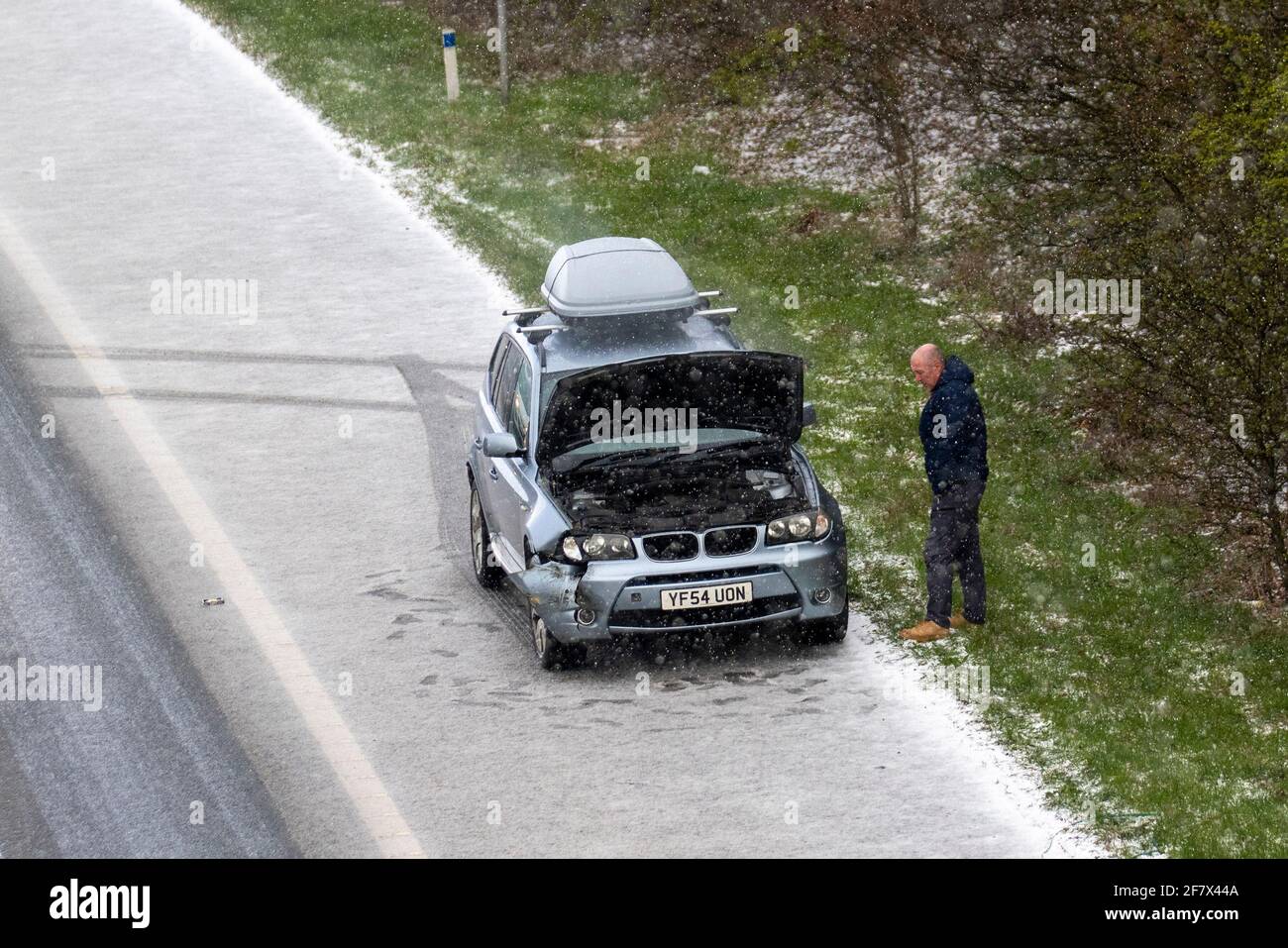 Chorley Lancashire. 10th April 2021 UK Weather;  Motorway mayhem as freak hail stone shower makes driving tricky with a series of collisions in Chorley. BMW 4 wheel drive vehicles in separate incidents collide with the armcor on the M61 central reservation. Credit MediaWorldImages/AlamyLivenews Stock Photo