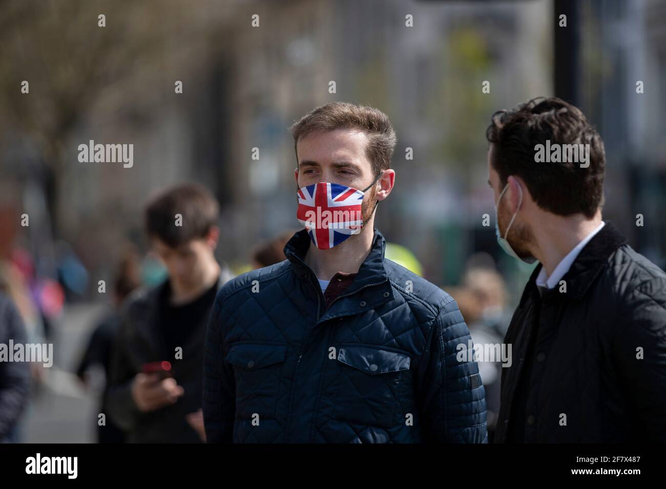 Cardiff, Wales, UK. 10th Apr, 2021. A man wearing a union jack face-mask stands outside Cardiff Castle in Cardiff city centre as a behind-closed-doors gun salute is held in the castle grounds to mark the death of Prince Philip. Credit: Mark Hawkins/Alamy Live News Stock Photo