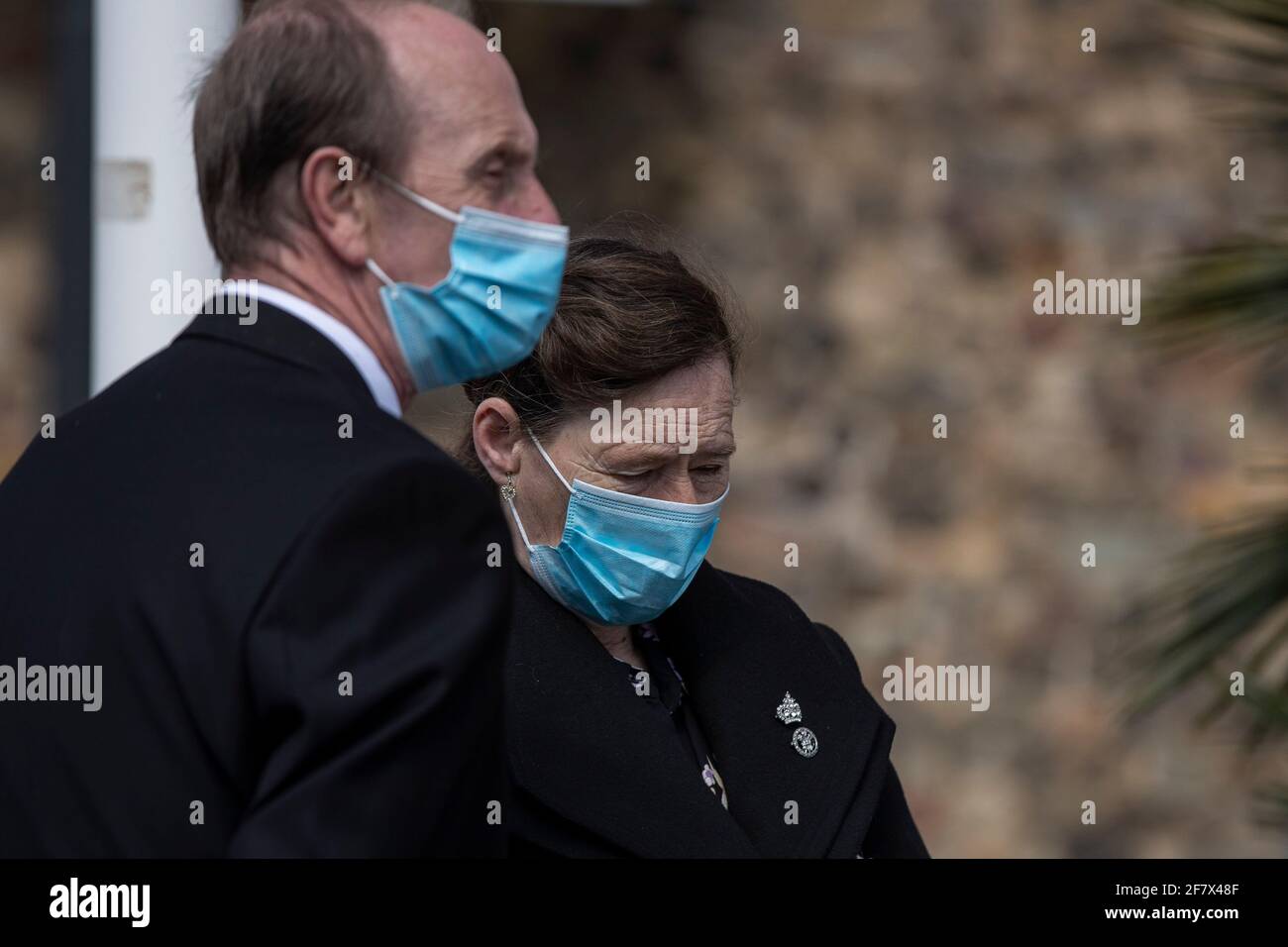 Cardiff, Wales, UK. 10th Apr, 2021. A woman wearing a royal crown broche appears emotional outside Cardiff Castle in Cardiff city centre as a behind-closed-doors gun salute is held in the castle grounds to mark the death of Prince Philip. Credit: Mark Hawkins/Alamy Live News Stock Photo