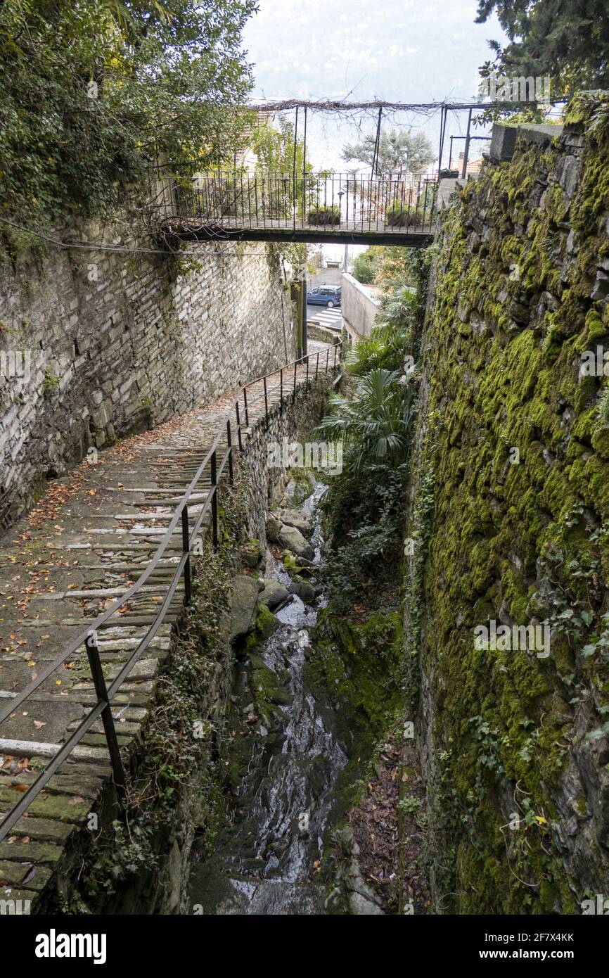 Vertical shot of a magical pathway through the old stone buildings ...