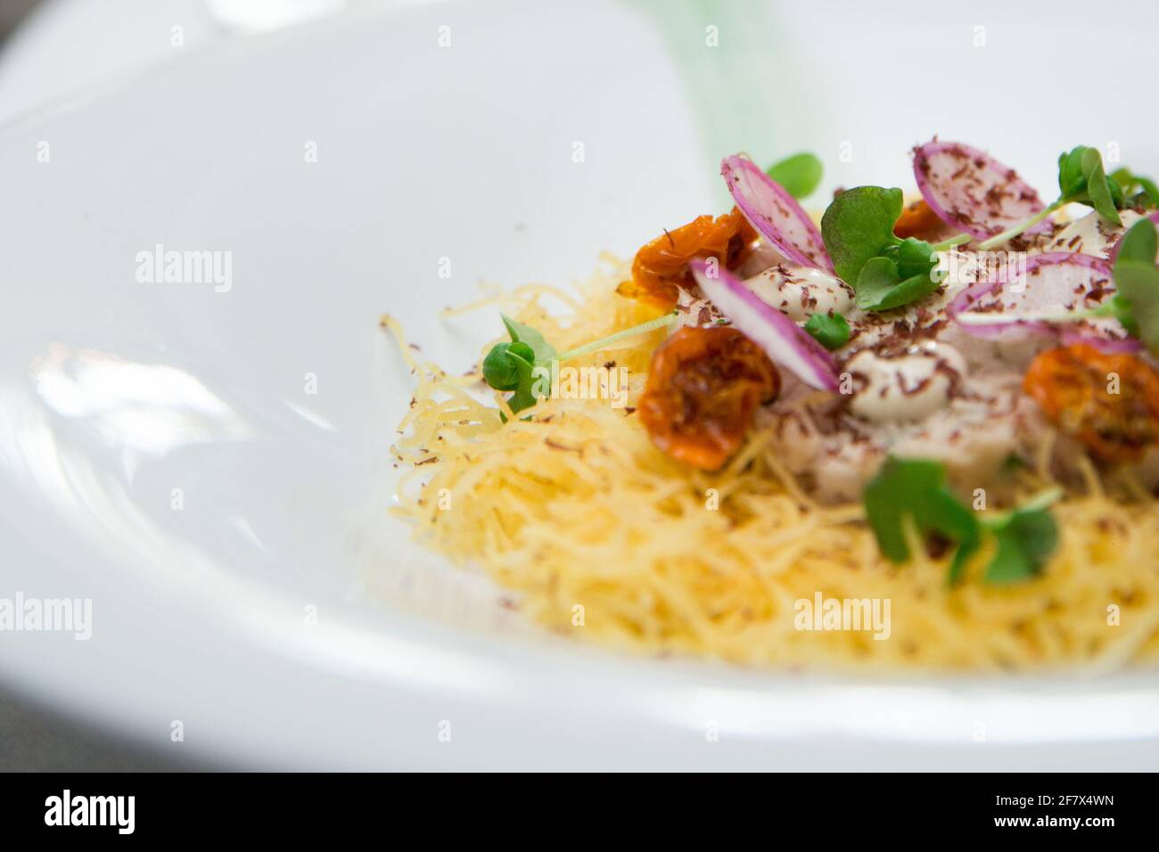 Delicious italian pasta dish served on a white cloth table in a fancy restaurant Stock Photo