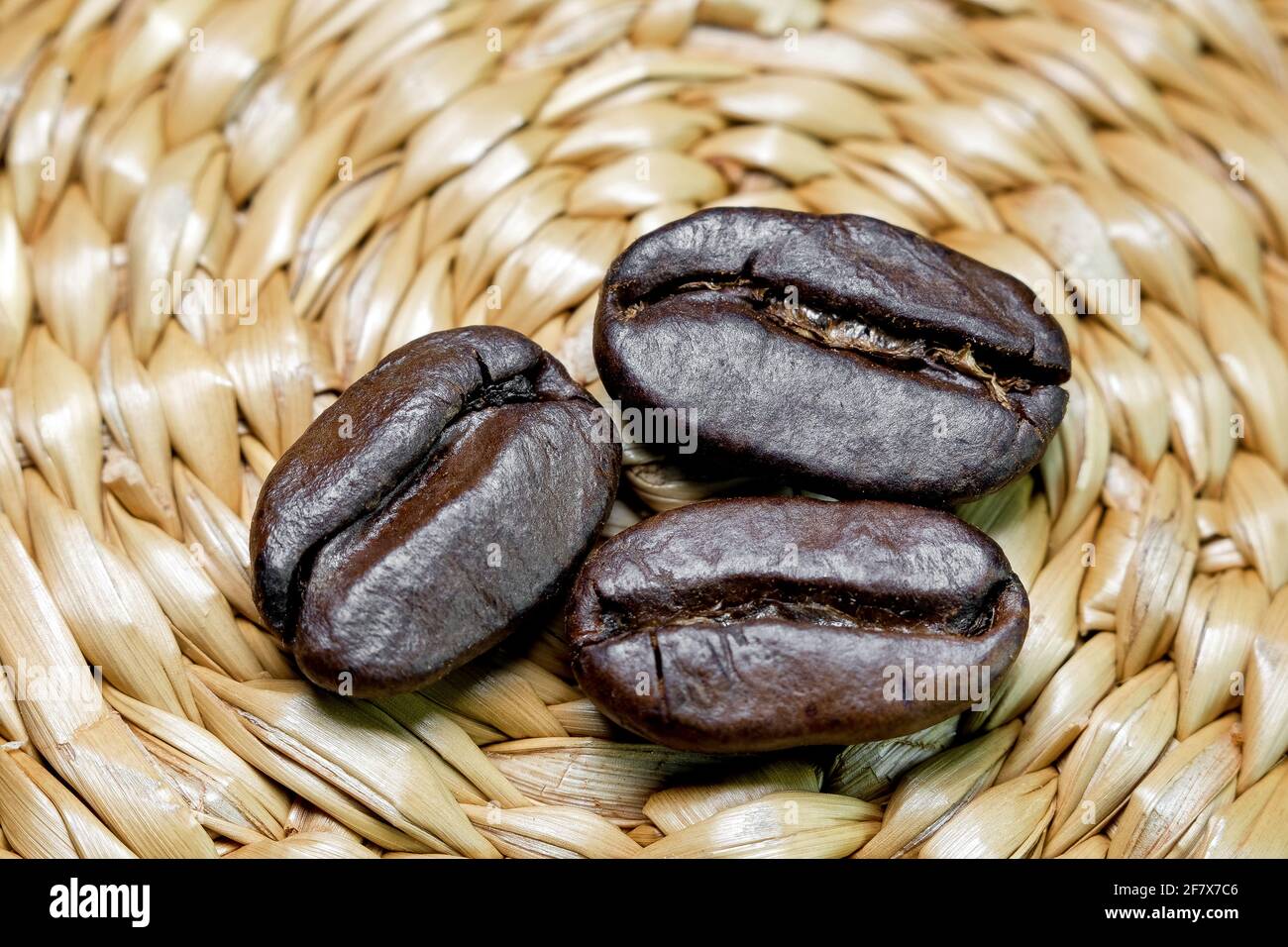 black coffee grains on a braided background photographed close-up Stock Photo