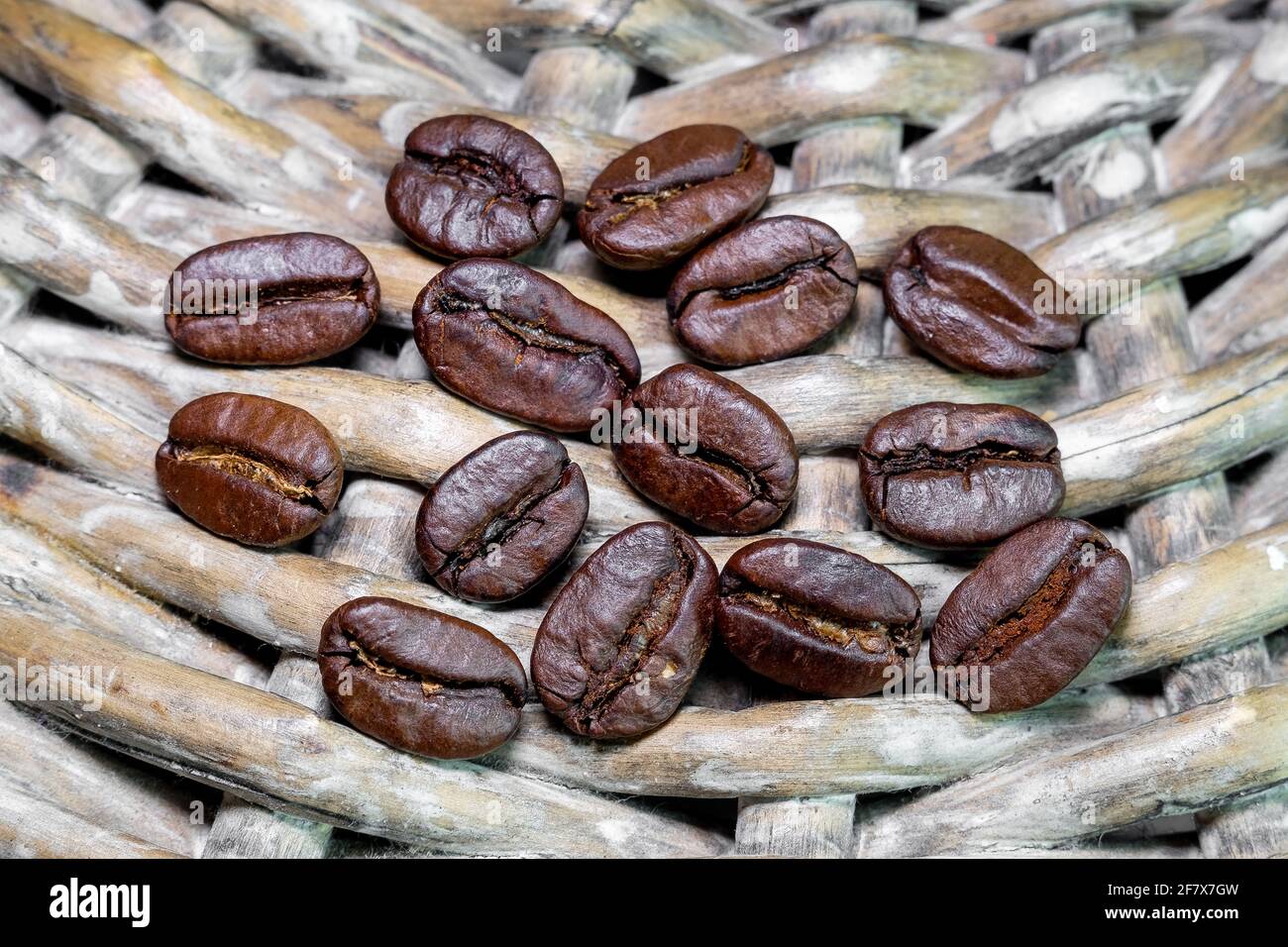 black coffee grains on a braided background photographed close-up Stock Photo