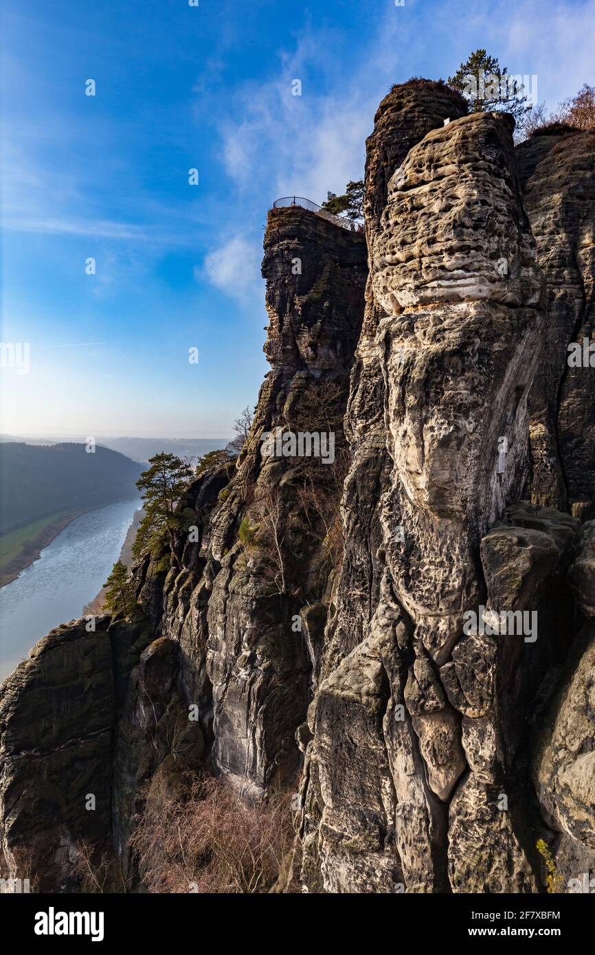 Aerial view of Elbe River and sandstone mountains of Bastei view platform  in Saxon Switzerland National Park in Lohmen on a sunny winter day with blu Stock Photo