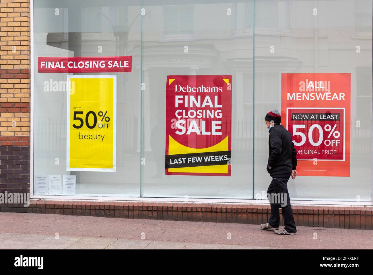 Debenhams store in High Street, Southend on Sea, Essex, UK, with closing down sale signs in the window display. Person passing. Final closing, shut Stock Photo