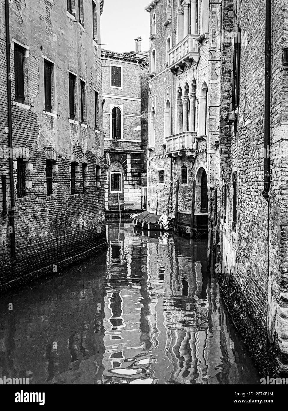 Black and white beautiful water reflections in the small canal, Venice, Italy Stock Photo