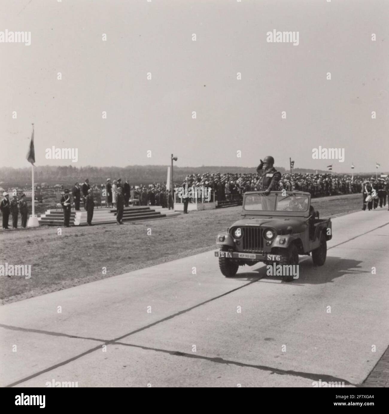 An M38A1 necking jeep with the parade commander passes the downlet point with O.A. Queen Juliana and Z.K.H. Prince Bernhard during the Parade in Ede on the occasion of Liberation Day. Stock Photo