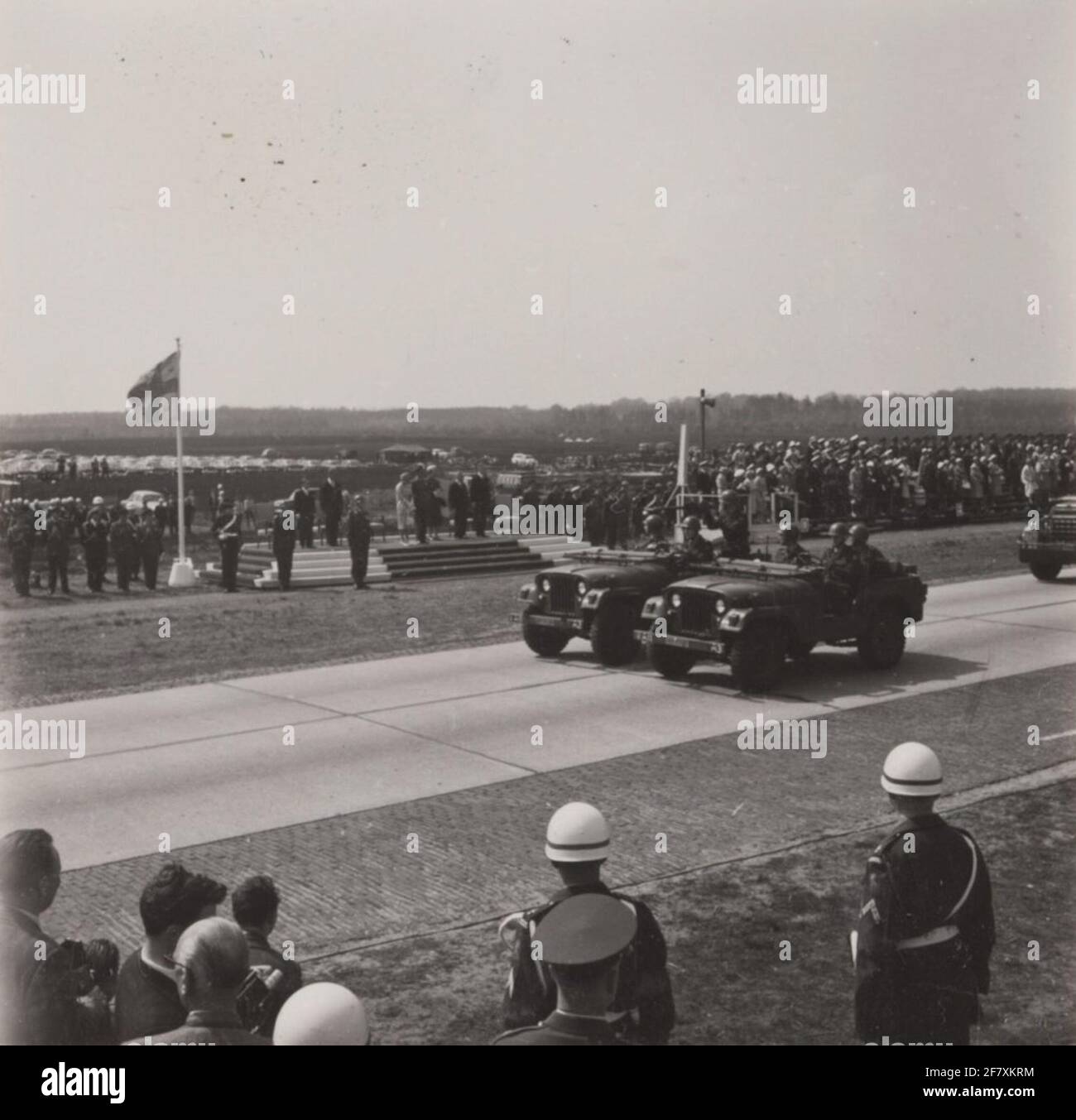 Two M38A1 necks Jeeps, the rear with a Browning M1919A4 .30 on affuit, passing the downfall with, among others, H.M. Queen Juliana and Z.K.H. Prince Bernhard during the Parade in Ede on the occasion of Liberation Day. Stock Photo