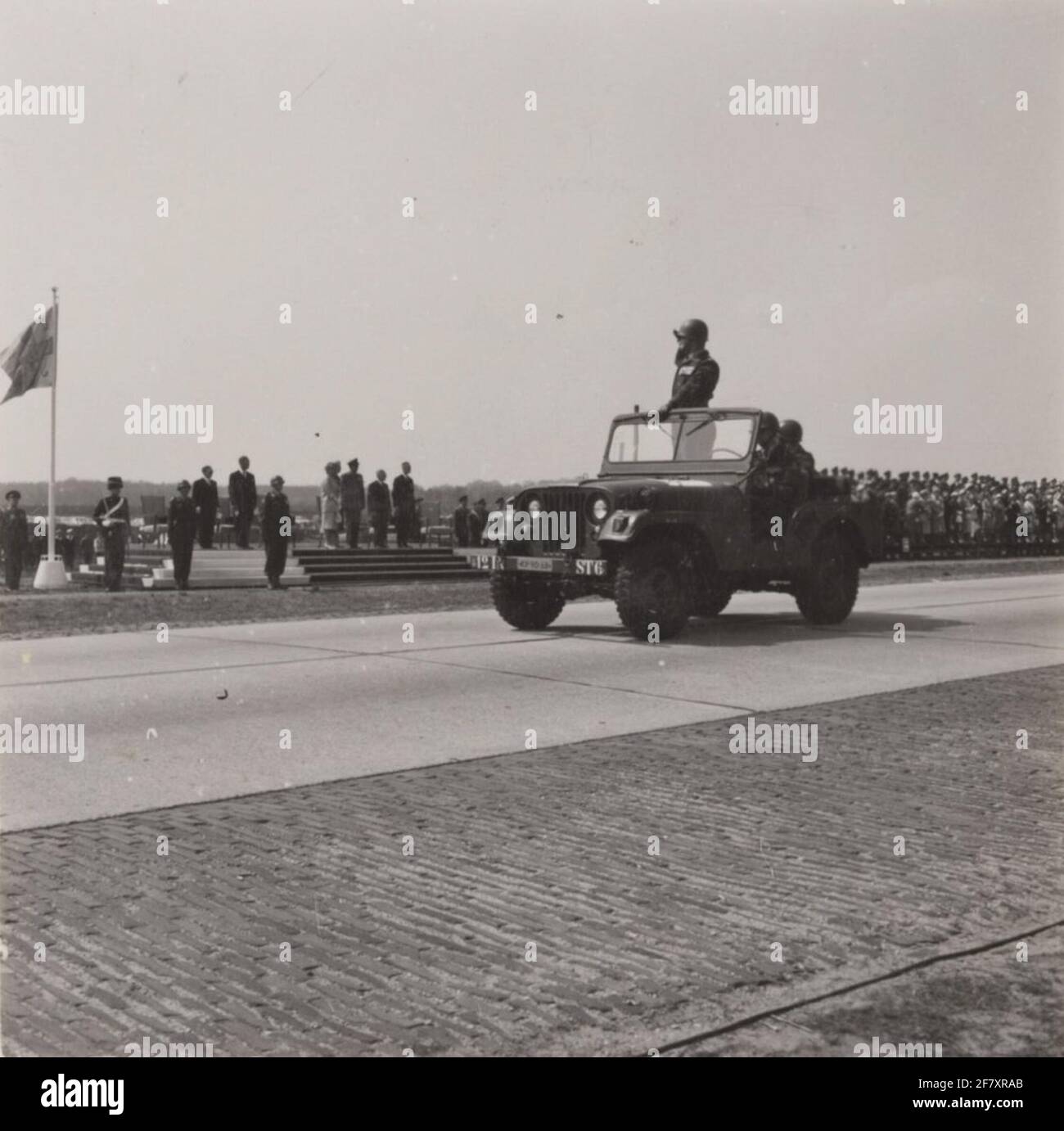 An M38A1 necking jeep with the parade commander passes the downlet point with O.A. H.M. Queen Juliana and Z.K.H. Prince Bernhard during the Parade in Ede on the occasion of Liberation Day. Stock Photo