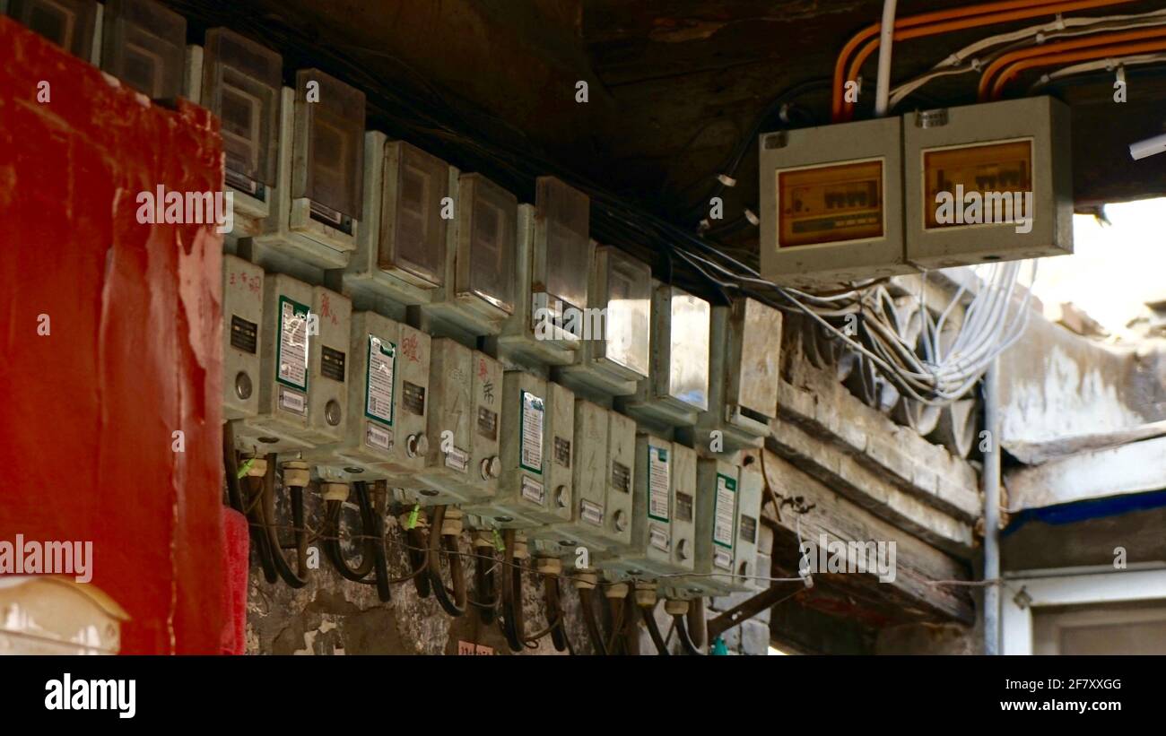 Old style electric meters hanging on the wall. Stock Photo