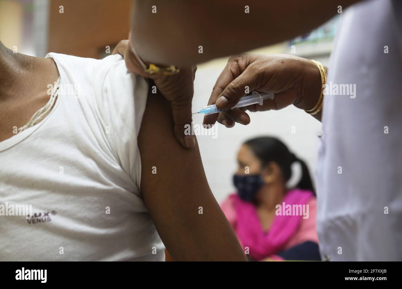 A man receives a dose of the India indigenous Covid-19 vaccine COVAXIN developed by Bharat Biotech during a vaccination drive at a government health care centre.The cumulative number of Covid-19 vaccine doses administered in the country on Friday exceeded 98 millions, nearly 34 lath vaccination doses were administered in the last 24 hours. (Photo by Naveen Sharma / SOPA Images/Sipa USA) Stock Photo